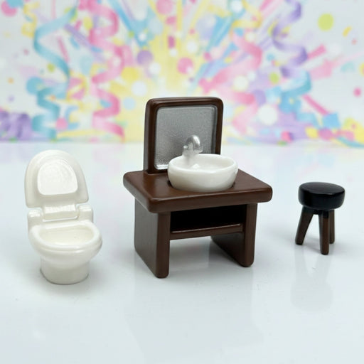 A collection of five miniature dollhouse furniture pieces and accessories on a grey surface, including a white and gold ornate wardrobe, a white classical bust statue, a gold harp, a white patterned coffee table, and a small red footstool.
