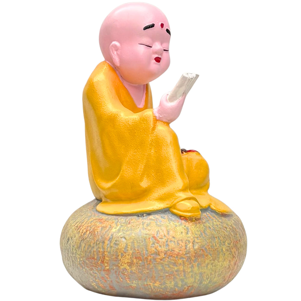 Zen Monk Figurine Reading on Stone