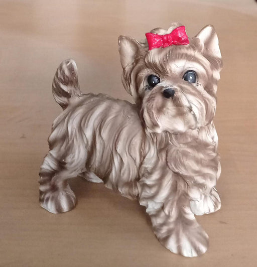 Small dog figure with bow accessory.