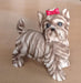 Small dog figure with bow accessory.