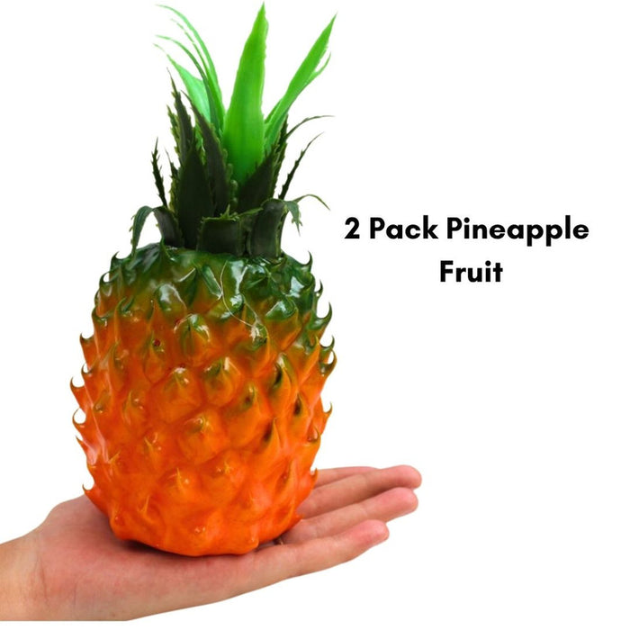 Set of two fake/faux pineapples, brightly colored orange bodies with spiky green leaves, used for home decor or staging.