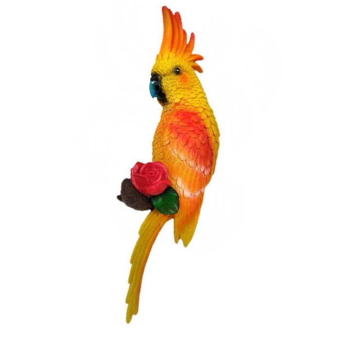 Yellow and orange resin parrot wall hanging sculpture with a large red rose.