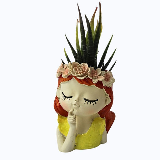 Close-up of a gardener easily lifting a lightweight, textured white resin planter by the rim.