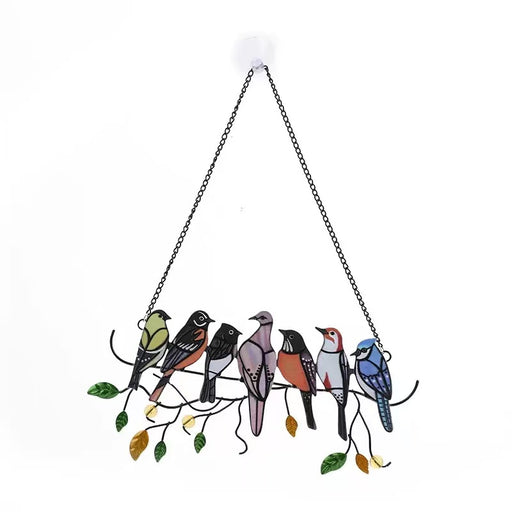 Hanging art piece featuring seven different colourful birds made from stained glass or acrylic, sitting on a black metal branch with green and gold leaves.