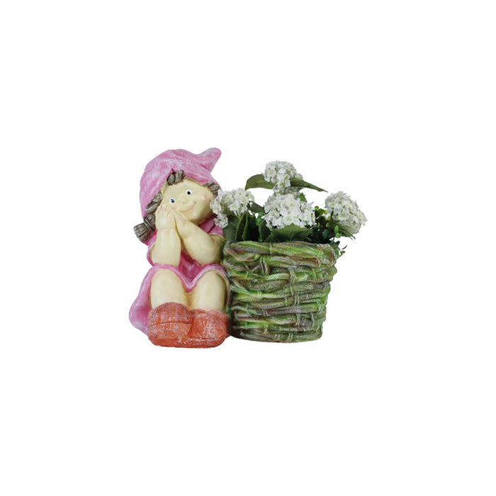 A decorative resin figurine of a smiling little girl wearing a pink hood and dress sitting next to a small green woven basket planter filled with white flowers, isolated against a solid white background.