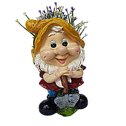 Two resin pigeon figurines perched together on a brown log base. One version shows pure white pigeons, while the other features pigeons with blue, grey, and pink plumage. Both are set against a green grass background with a white picket fence.