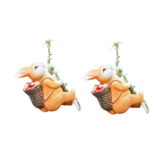 Pair of hanging resin bunny statues climbing a rope with fruit baskets, whimsical garden duo, hand-painted rabbit ornaments for outdoor trees.