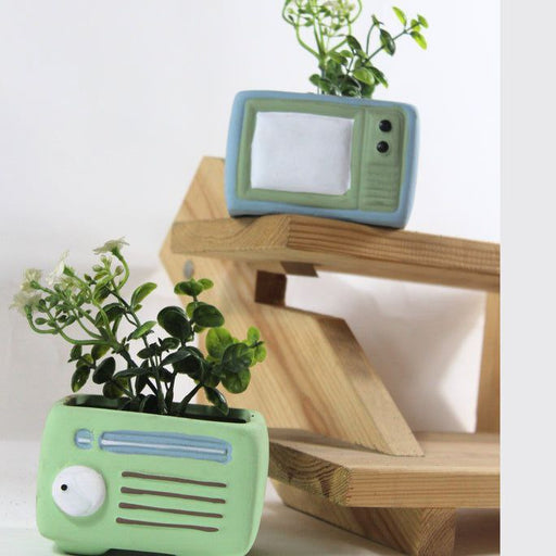 Rectangular resin garden planter on a stone patio filled with vibrant petunias.