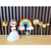 Little Princess doll cake topper set in clear packaging, including a doll in a white dress, three gold spherical balloon toppers, a colorful rainbow decoration, and a 'PARTY' banner. Perfect for a girls' birthday or baby shower cake.