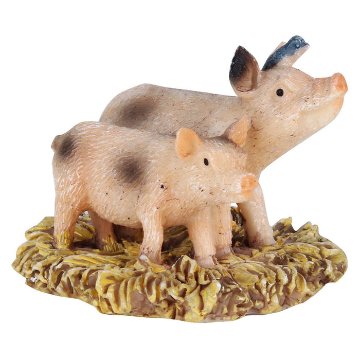 A miniature resin figurine of a spotted pink mother pig and her piglet standing on a textured yellow hay base, isolated on a white background.