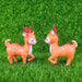 A pair of cute, identical miniature cartoon deer figurines with bright orange coats, white underbellies, rosy cheeks, and reddish-brown antlers standing side-by-side against a solid white background.