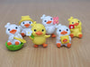 Set of six miniature tourist duck figurines with accessories like a camera, chips, and sun hat, decorative resin ducks for fairy gardens and desk decor.