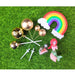 A complete set of cake toppers featuring a small, red-haired Mermaid figure, a colorful Rainbow with two white Clouds, a tiny banner, and several different-sized Metallic Gold Ball toppers on white and green picks, all displayed on a wooden table.