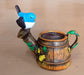 Decorative miniature watering can planter with a blue bird figurine.