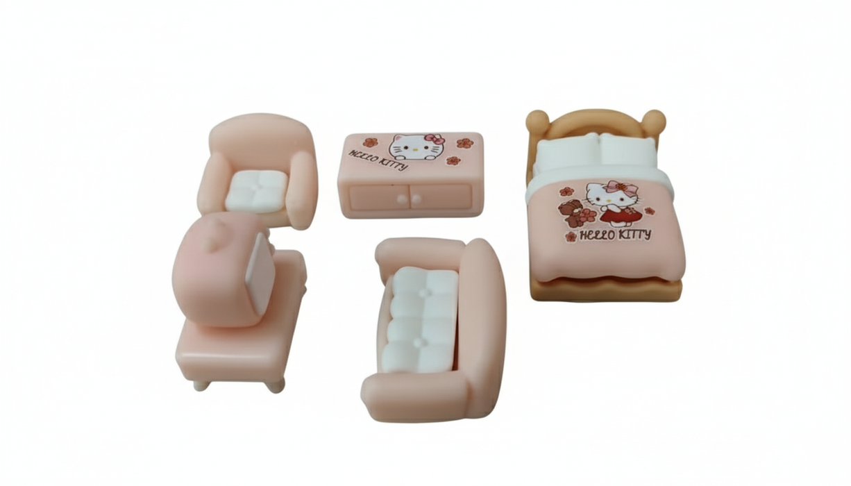 A high-contrast image of a miniature, 5-piece pink and white Hello Kitty dollhouse furniture set. The set includes a bed with a Hello Kitty comforter, a dresser/cabinet, two armchairs with white cushions, and one chaise lounge chair.