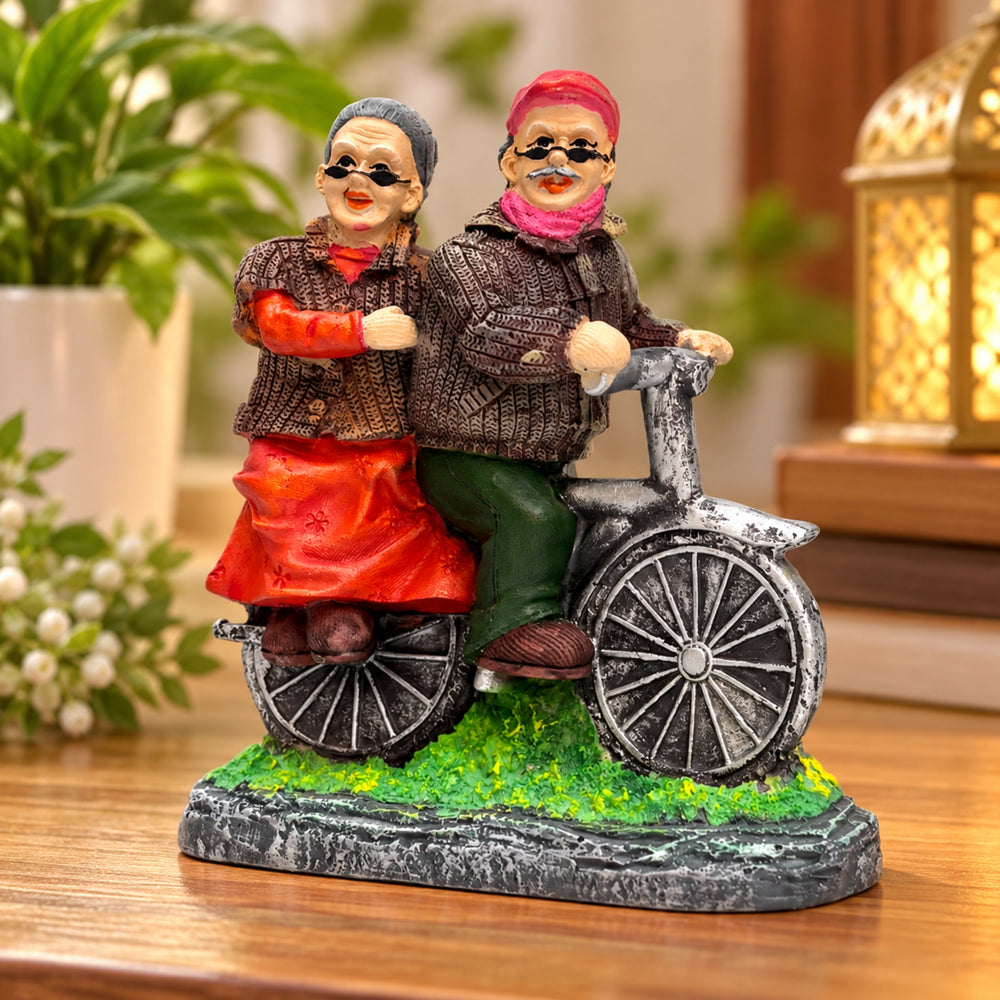 Hand-Painted Grandparents on Bicycle Figurine