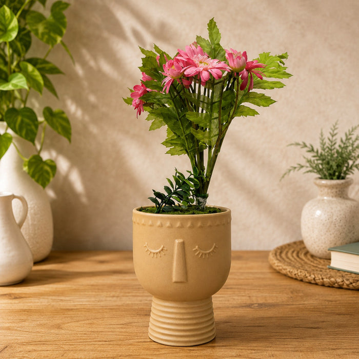 ceramic face planter pot with a minimalist closed-eye design and a pedestal base