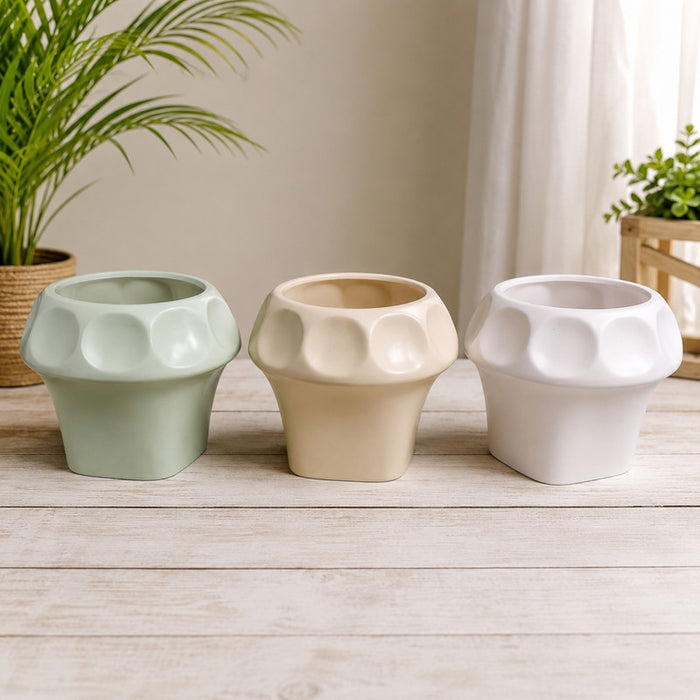 Set of three modern geometric textured planter pots in pastel green, beige, and white colors
