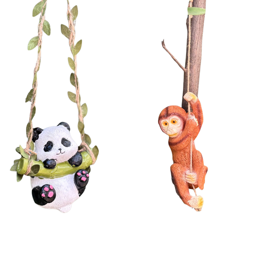 Two decorative garden figurines: a small panda sitting on a green bamboo swing hanging from leafy vines, and a brown monkey climbing a rope attached to a branch. Both are set against a plain white background.