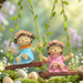 Two whimsical hand-painted girl figurines wearing flower crowns and colorful dresses (pink and blue), sitting on wooden-style swings decorated with green vines and hanging from twine.