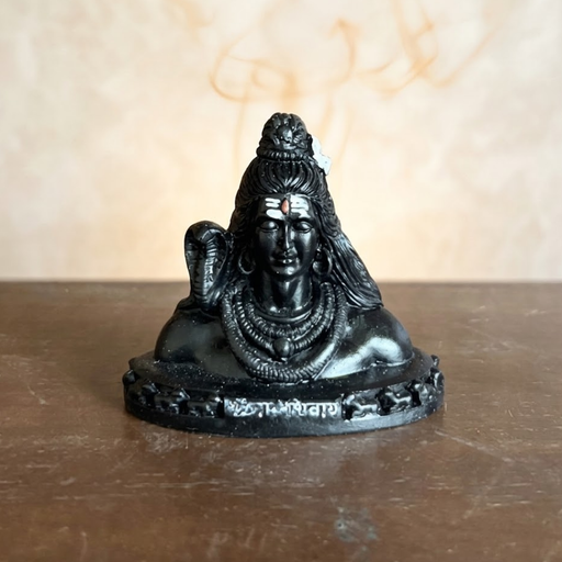 Black resin bust of Hindu deity Lord Shiva Adiyogi with a serpent around his neck, set against a wooden slatted background.