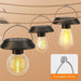 Three portable solar-powered hanging LED lights with clear bulbs suspended on a rustic rope line