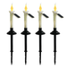 Set of four solar-powered garden stake lights with flickering yellow flame bulbs and white candle bodies