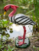 Handcrafted resin crane garden statue with vibrant red head and long bill standing on a textured green base outdoors