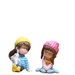 Two miniature figurines of girls in winter gear; one wearing a yellow beanie and blue jacket holding a white rabbit, and another in a pink beanie and pink jacket sitting cross-legged.