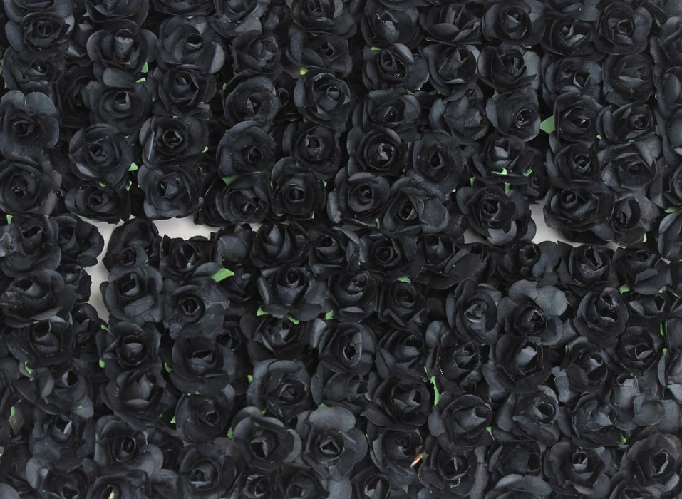 A high-angle, detailed close-up of a large collection of artificial miniature black roses arranged in a dense pattern.