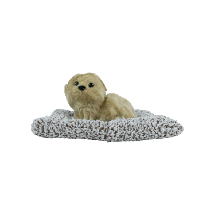A cute, fluffy beige miniature plush dog sitting on a soft, textured grey-and-white mat against a plain white background.