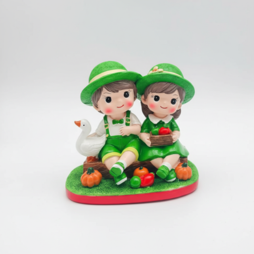 A colorful resin figurine of a young boy and girl in green outfits sitting on a log with a white duck, a basket of fruit, and miniature orange pumpkins on a green base.