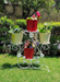 White metal four-tier plant stand featuring decorative floral accents and scrollwork