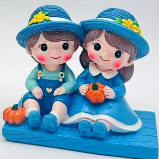 Hand-painted miniature figurine of a boy and girl couple in blue outfits and sun hats, sitting on a blue base with small orange pumpkins.