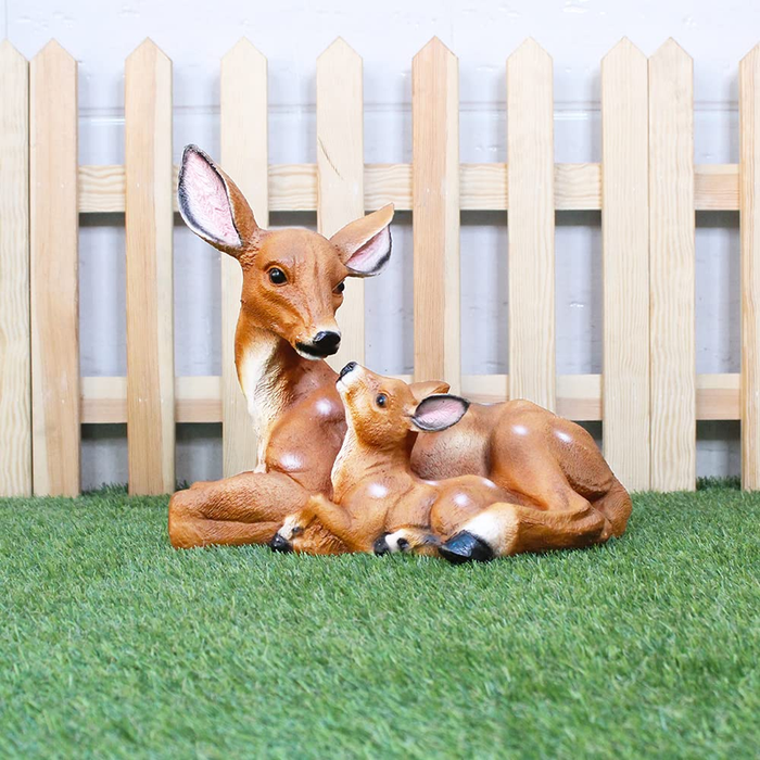 Resin figurine of a mother deer resting with her fawn