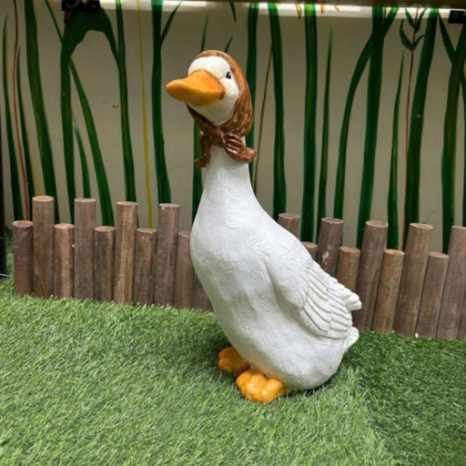 A white duck garden statue wearing a brown hand-painted babushka headscarf,