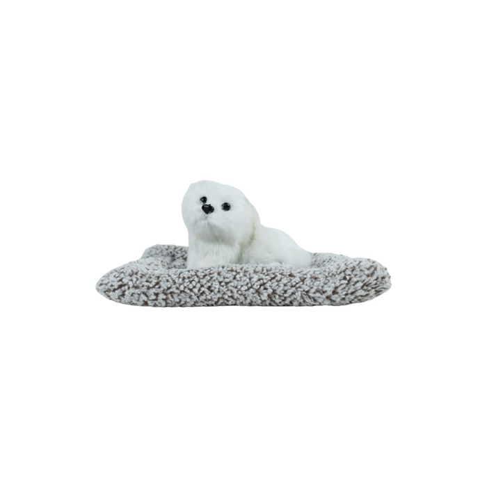 A cute, fluffy white miniature plush dog sitting on a soft, textured grey-and-white mat against a plain white background.
