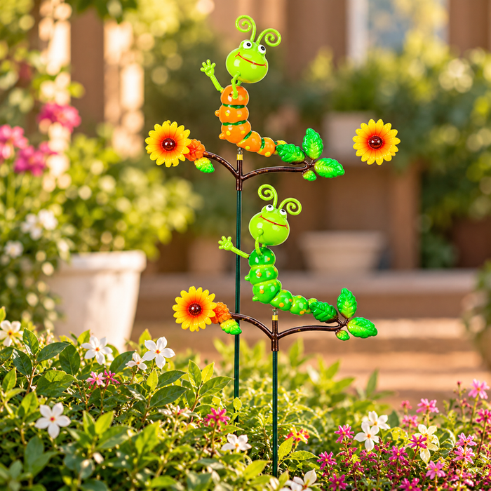 Set of 2 colorful caterpillar garden sticks with flowers and leaves in a lush outdoor garden