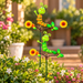 Set of 2 colorful caterpillar garden sticks with flowers and leaves in a lush outdoor garden