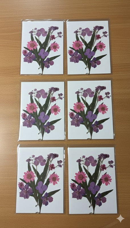 Set of six matching framed botanical artworks featuring real pressed flowers in shades of purple, pink, and white, displayed against a light background.