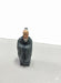 Small statue of an old Chinese monk with a white beard and a dark gray robe.