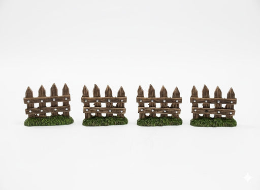 Four miniature dark brown picket fences with green grass bases, arranged in a row against a white background.