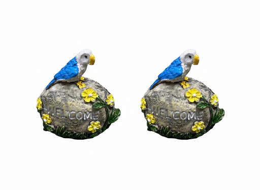 Blue and white resin parrot garden statue on a rock with 'WELCOME' engraved and yellow flowers.set of 2