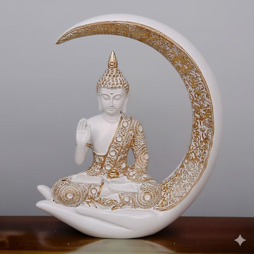 White and gold Buddha showpiece seated in a meditative pose within a crescent moon showpiece.