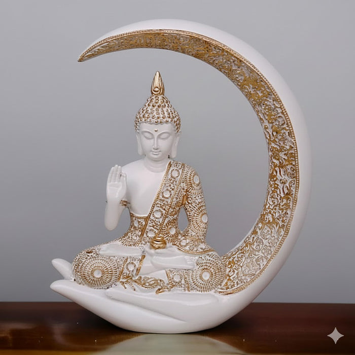 White and gold Buddha showpiece seated in a meditative pose within a crescent moon showpiece.