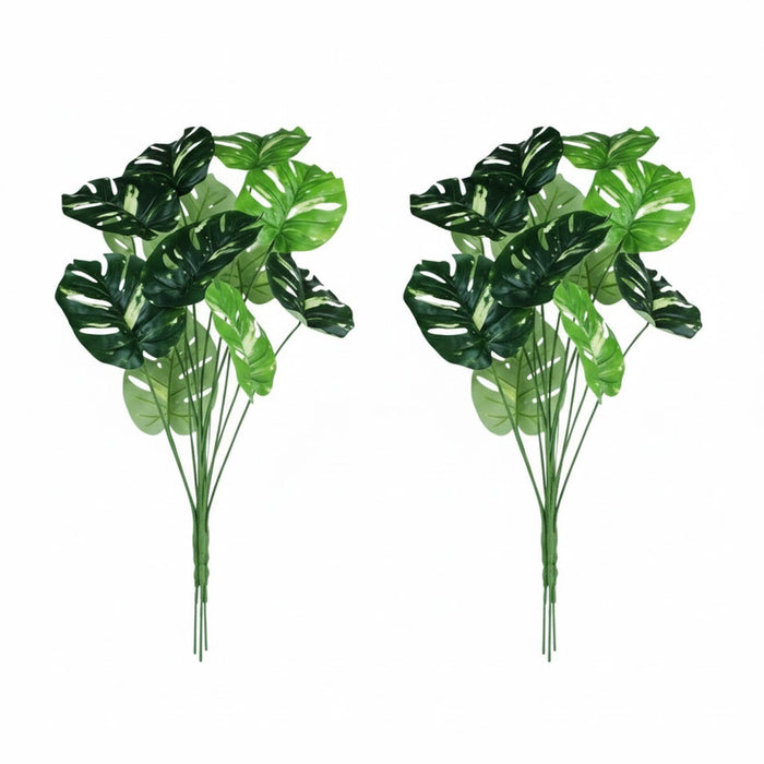 Set of 2 realistic artificial Monstera Deliciosa plants with large variegated split leaves in black nursery pots for indoor home and office decoration.