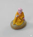 Small orange-robed monk figurine reading a book, peaceful Zen Buddha statue for home office desk and bookshelf decor.