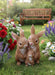 Three joint rabbit figurines in a family huddle, made of textured dark brown resin.