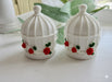 White miniature birdcage favor containers decorated with red roses and green leaves on a white surface.-set of 2