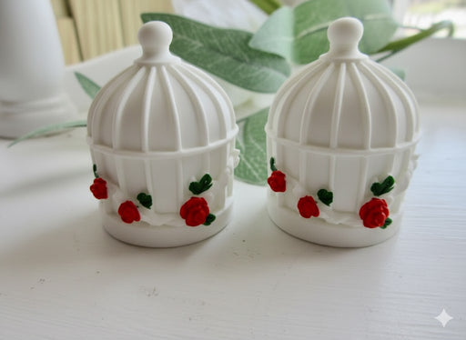 White miniature birdcage favor containers decorated with red roses and green leaves on a white surface.-set of 2